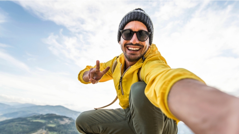 Man exploring the mountains while on his Interrail trip 